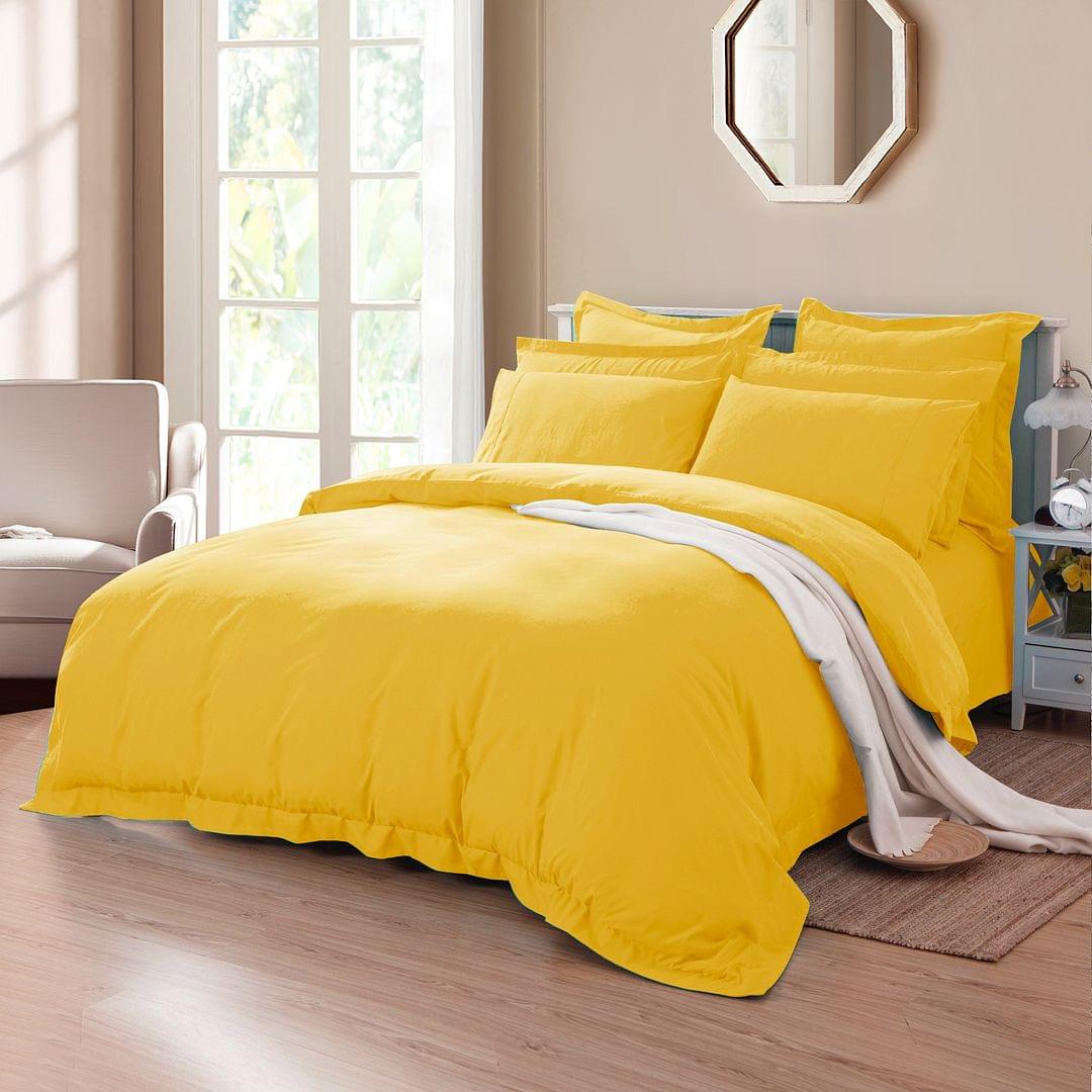 Yellow duvet quilt cover set with pillowcases on a made bed