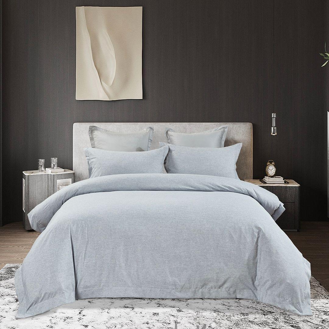 Light blue king quilt cover on bed with four matching pillow shams