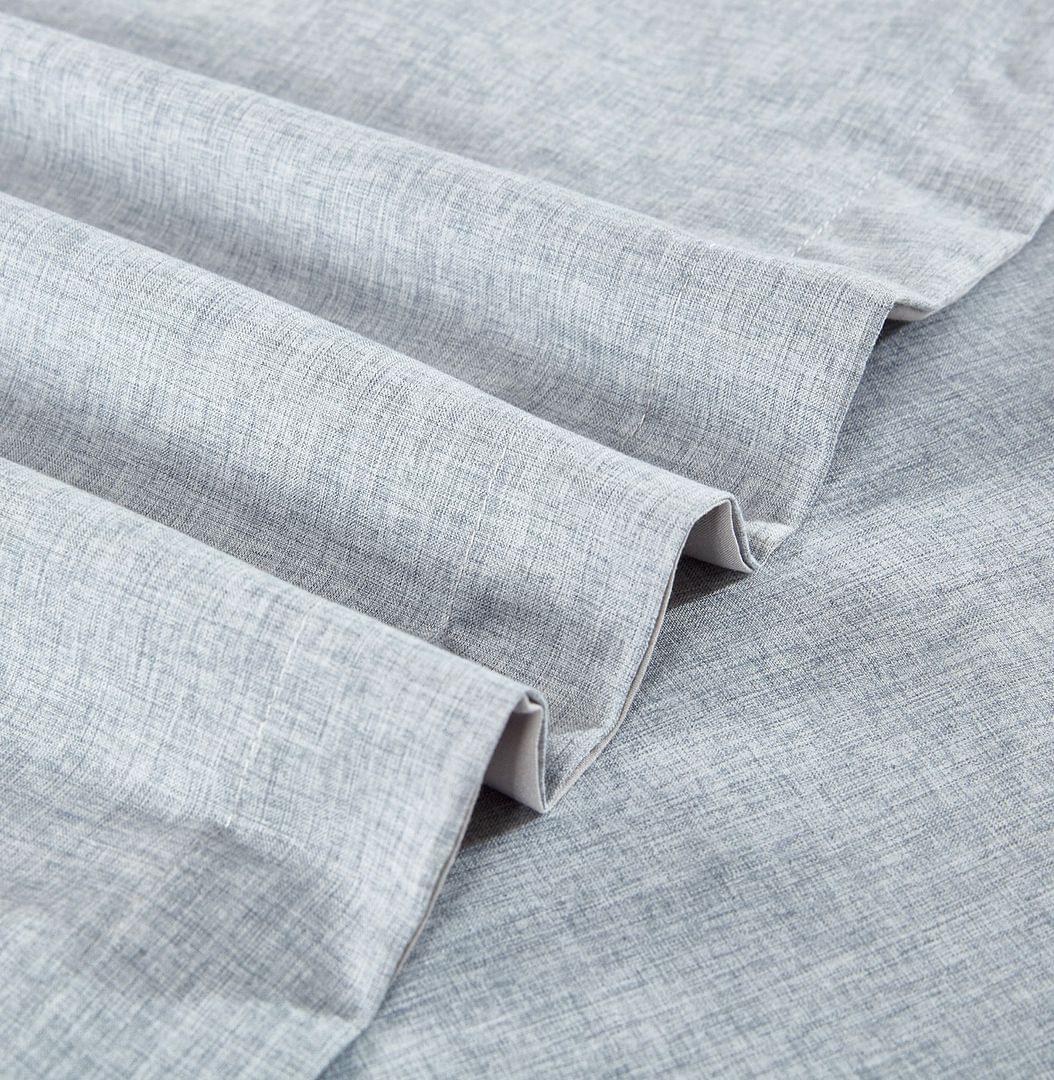 Light blue quilt cover corner with stitched hem and folded fabric
