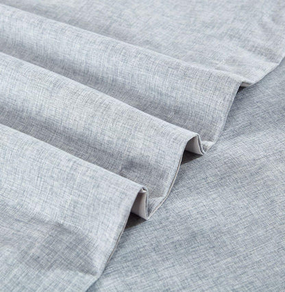 Light blue quilt cover corner with stitched hem and folded fabric