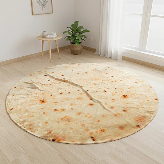 Round cream speckled tortilla-style blanket throw rug laid on light wood floor.