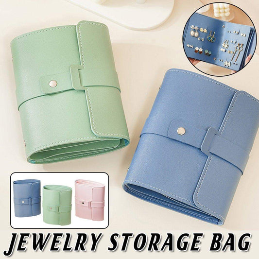 Blue travel jewelry storage bag with snap-buckle strap closure