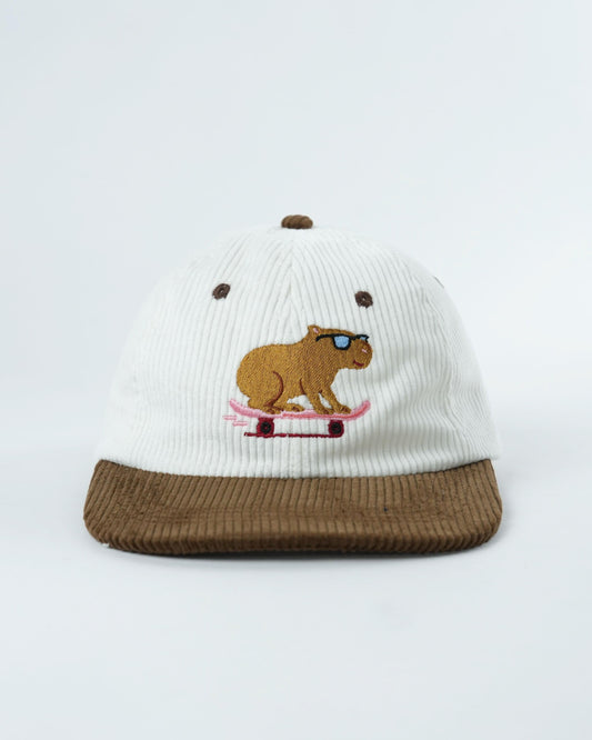 White ribbed beanie hat with brown brim and skater rat graphic
