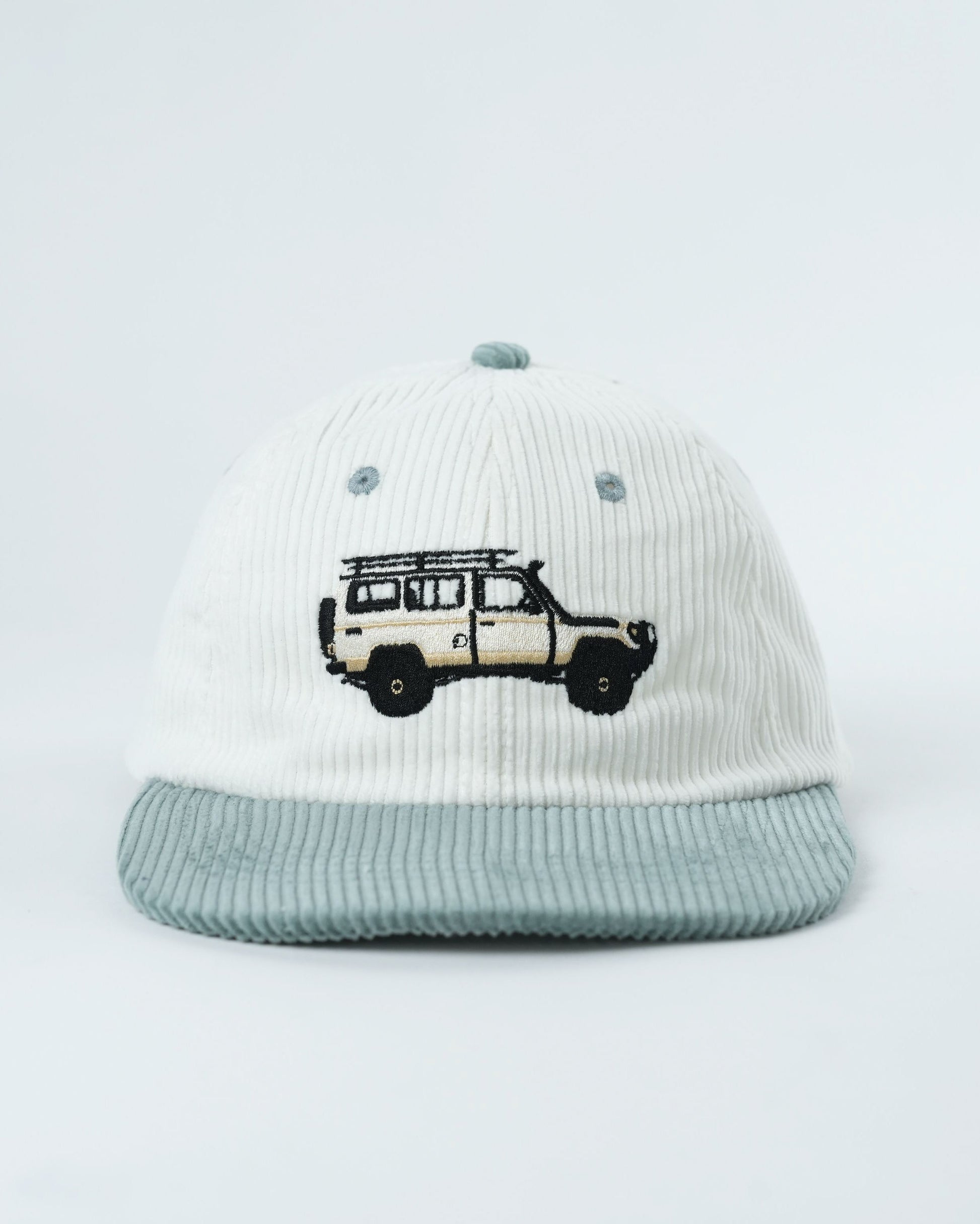Troopy hat in white ribbed knit with teal brim and embroidered truck logo.