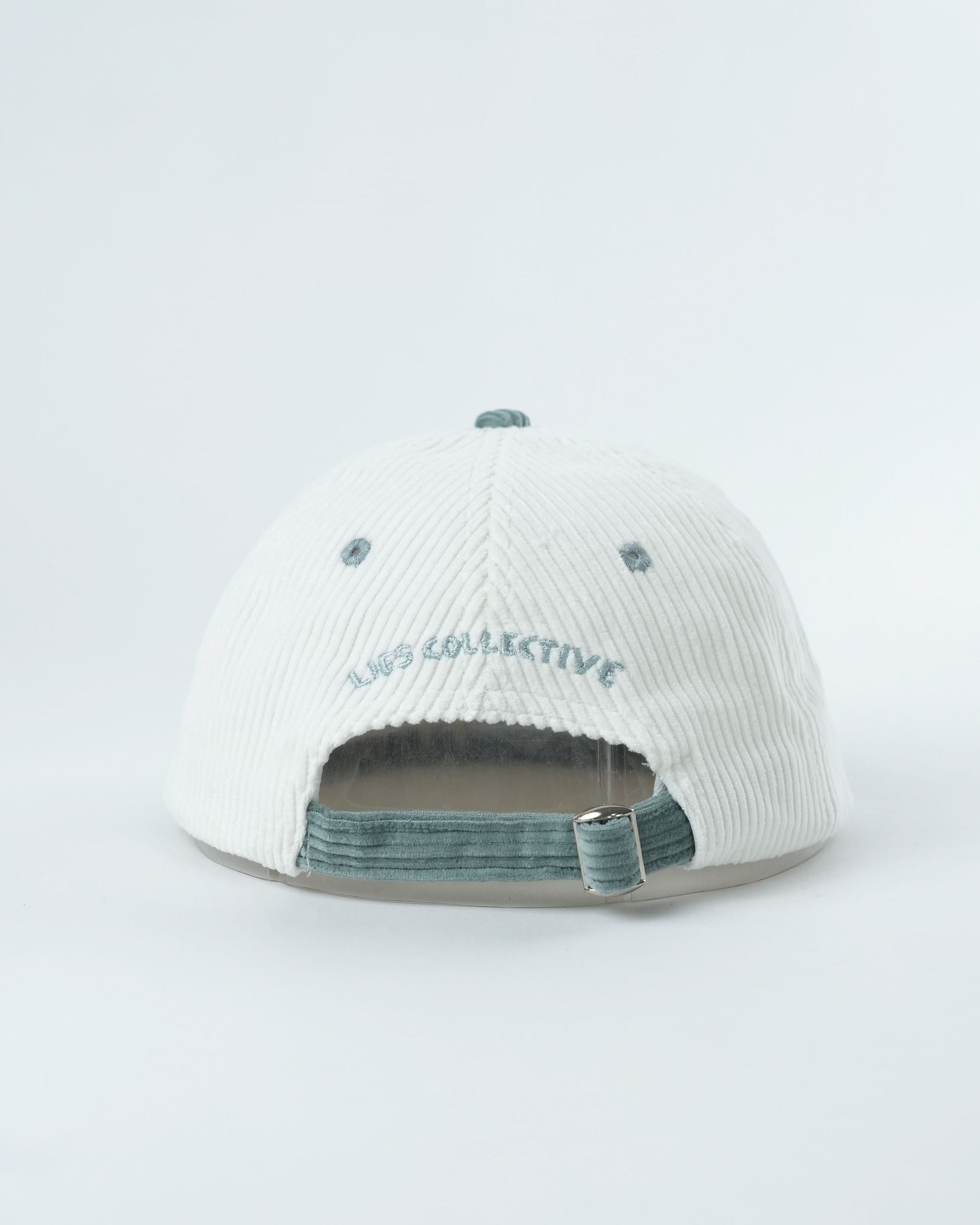 Troopy hat back view with white ribbed fabric and teal adjustable strap.