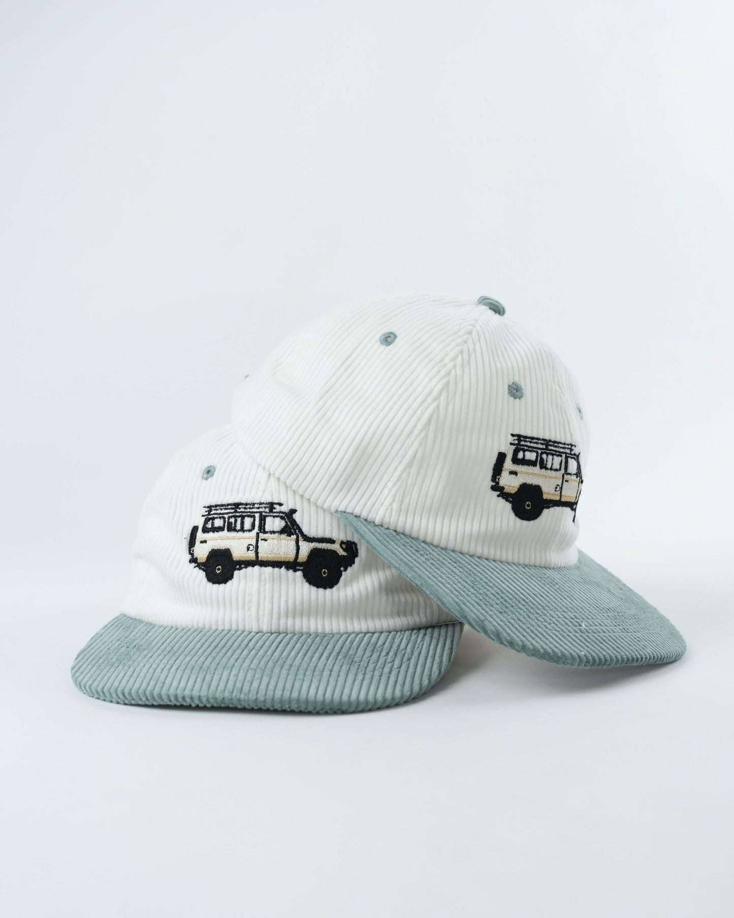 White ribbed cap with teal brim, two embroidered van views, side profile