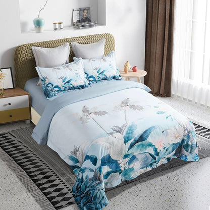 Tropical quilt cover set on bed with blue and white palm leaf pattern and matching pillowcases