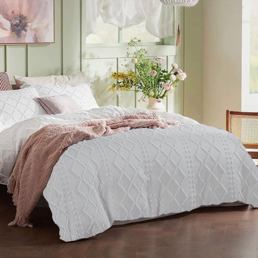 White quilt with diamond quilting and raised tufted pattern on bedding
