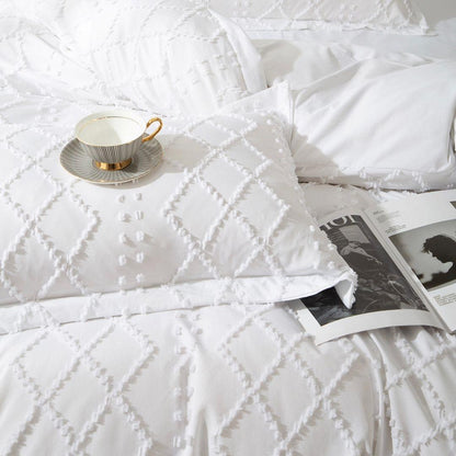 White tufted quilt with diamond embossed stitching and raised textured motifs