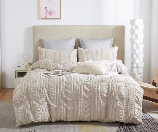 King quilt and pillow sham set with vertical striped embroidery, textured cream fabric