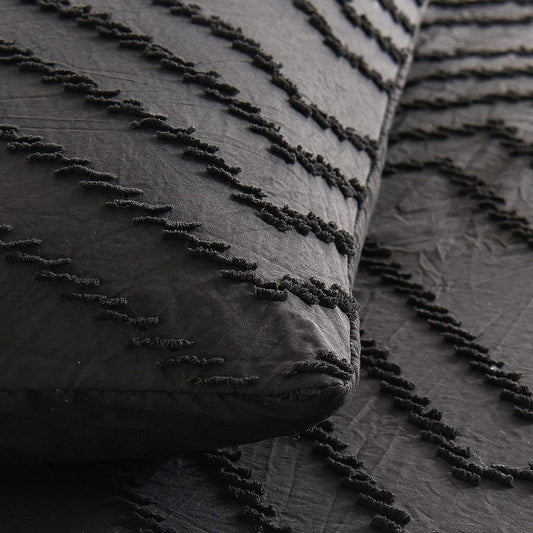 Black wave jacquard duvet cover closeup with textured fringe trim along edges