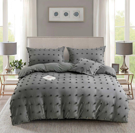 Grey tufted dot jacquard duvet cover set with two shams, centered bed view