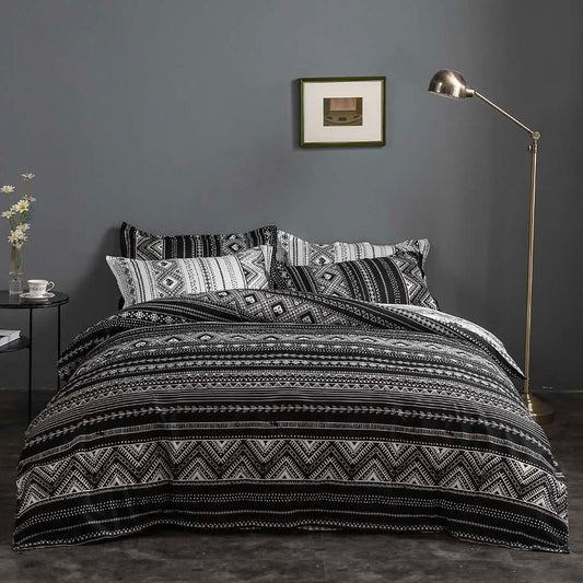 Black-and-white reversible quilt and duvet cover set with bold horizontal bands