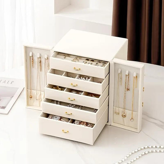 White jewelry storage box with open drawers and side compartments for necklaces