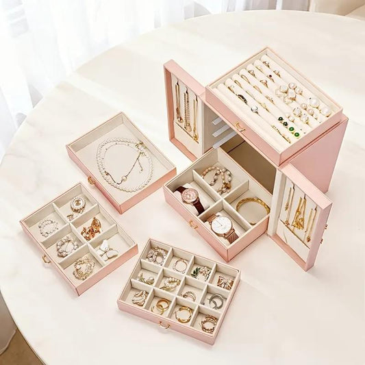 Set of pink faux leather jewelry storage boxes with compartments for bracelets and earrings