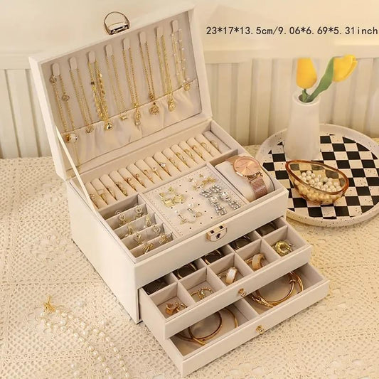White jewelry storage box with open drawers and necklace, earring, and ring compartments