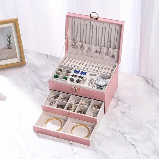 Pink jewelry storage box with open drawers and necklace rods for rings and earrings