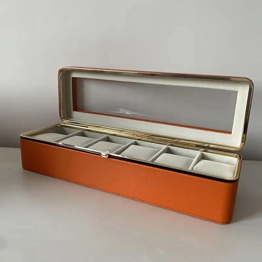 Brown watch storage box with clear window lid and fabric-lined compartments for six watches