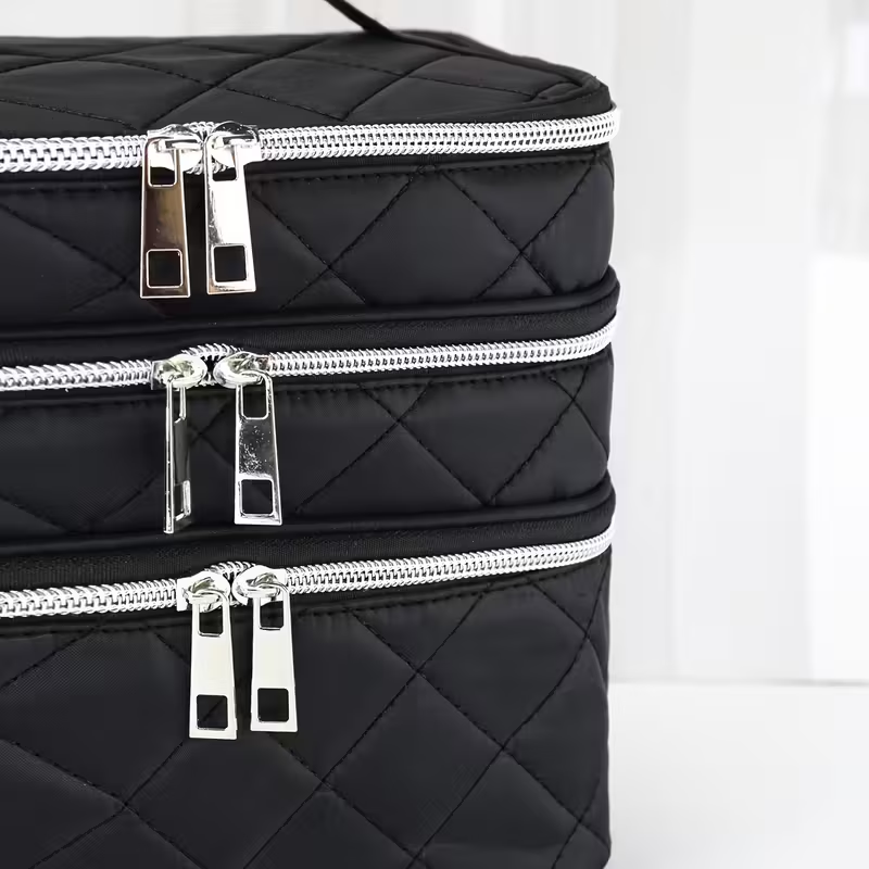 Fashionable and light luxury large-capacity black embroidered diamond-shaped cosmetic bag with three  for multi-level storage, portable and hand-held, suitable for home and travel use.