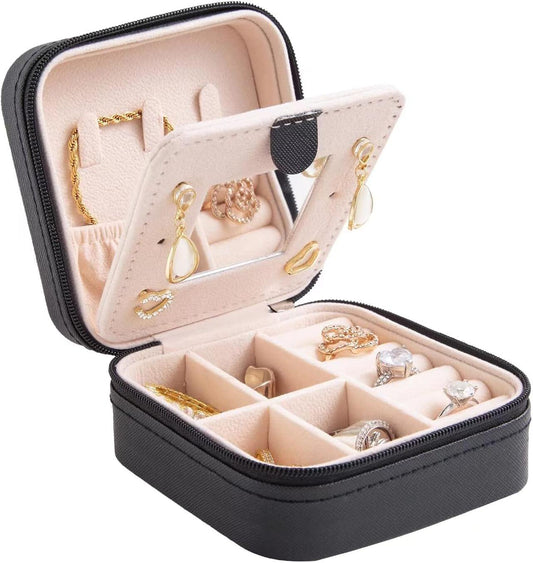Compact black travel jewelry box with hinged mirror and jewelry compartments