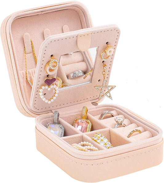 Pink travel jewelry box with mirror, open compartments for rings and earrings