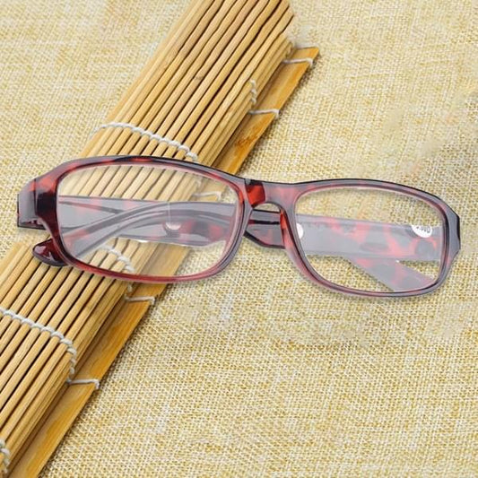 Black reading glasses with rectangular optical frames and red accent arms