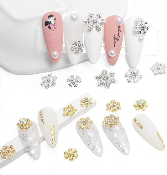 Snowflake nail charms with rhinestones, scattered pieces and on manicured nails
