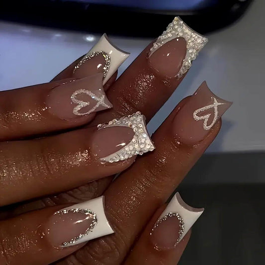 Nude short square press-on nails with white French tips and rhinestone heart accents