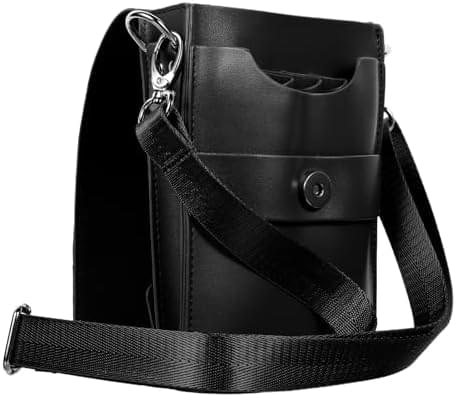 Black leather scissor bag with side ring, front snap, and wide crossbody strap