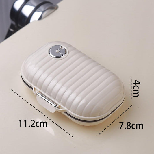 White portable pill organizer case with snap latch and ribbed lid, top view
