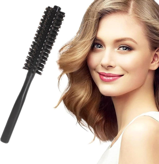 Black round hair dryer brush with dense boar-style bristles on a straight handle