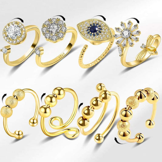Set of gold antistress fidget rings with crystal and blue stone details