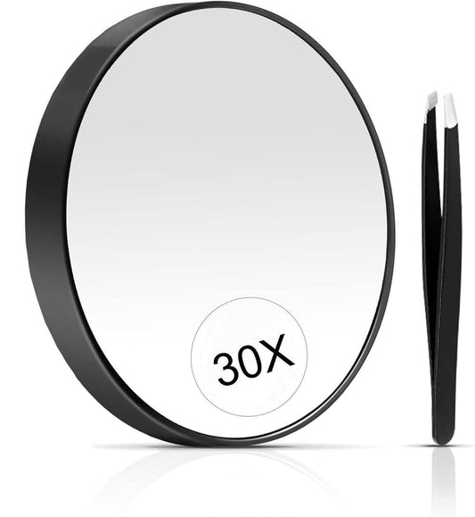 Black round magnification makeup mirror with 30X inset and black tweezers.