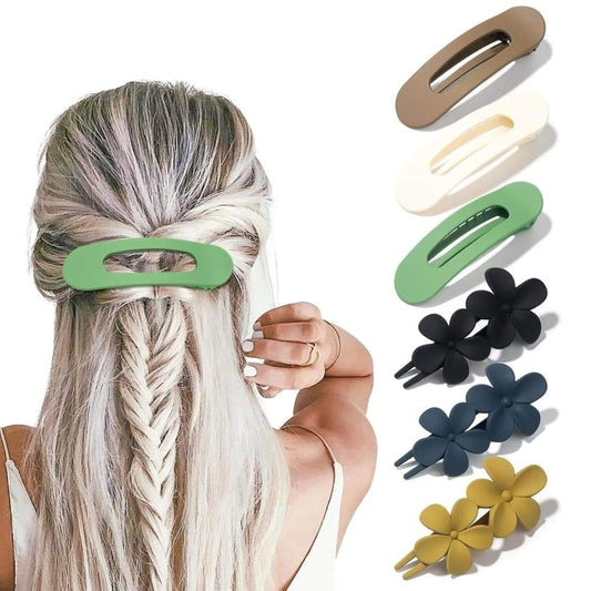 Large hair claw clips set with beige, white, green, and black flower designs