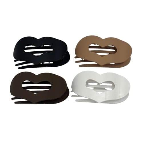 Four flat hair clips in black, brown, white, and tan with ridged centers