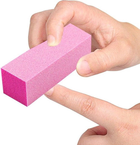 Pink nail buffer block held between fingers, rectangular foam tool