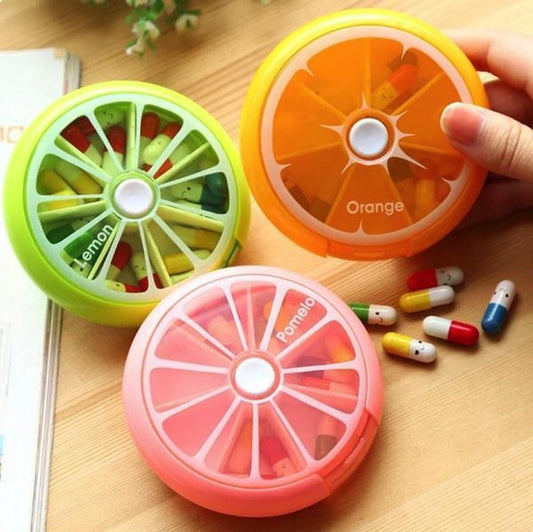 Orange round pill box with citrus-slice lid and visible pills inside
