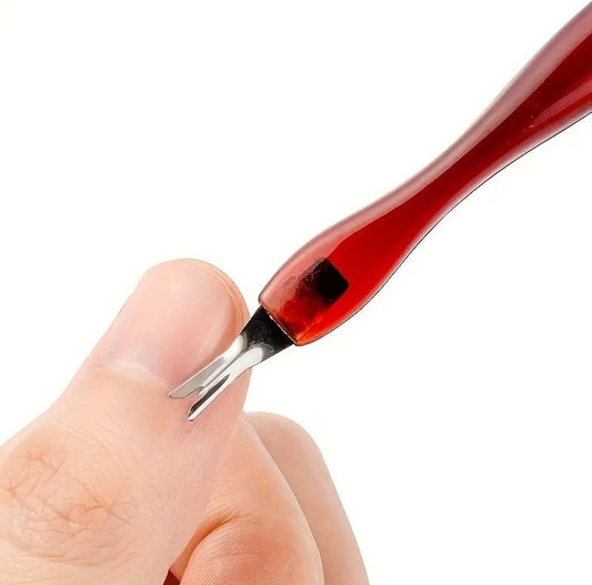 Cuticle remover fork tool on fingernail, metal tip