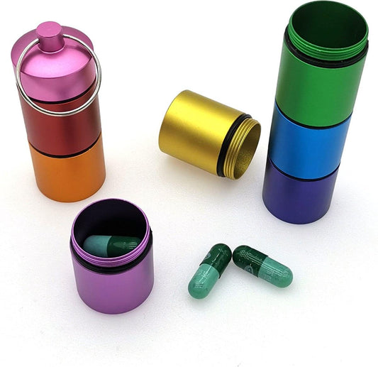 Multicolor reversible pill box tube with compartments, open lids and small capsules inside