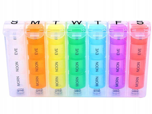 Pill organizer close-up with labeled MORN/NOON/EVE/BED compartments in rainbow colors