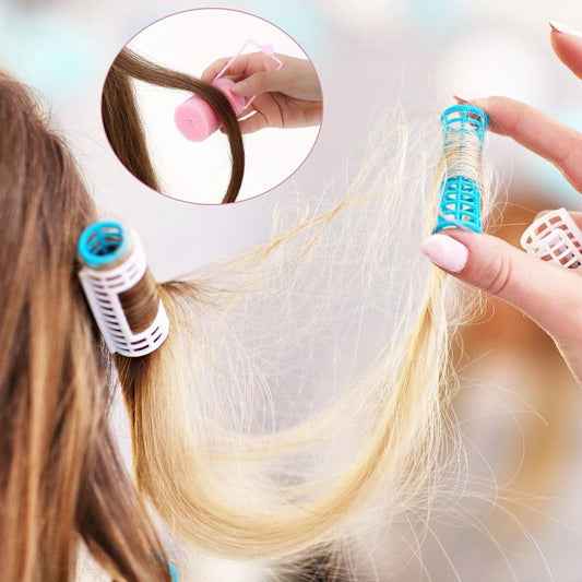 Pink foam hair curlers being placed on long hair by hand
