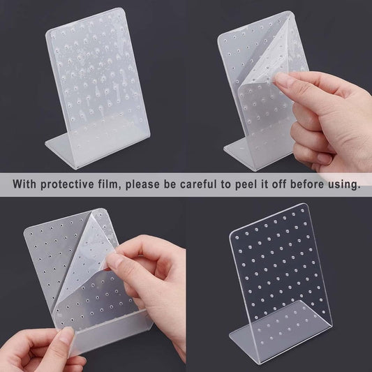Clear acrylic earring display stand with protective film being peeled off by hand