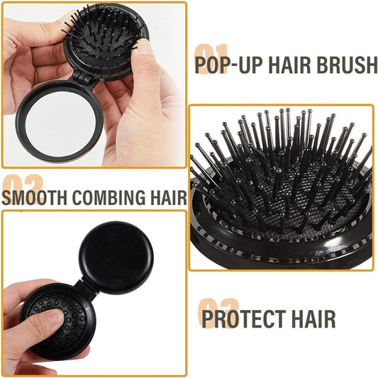 Foldable compact hair brush with mirror, black bristles, shown folded in hands