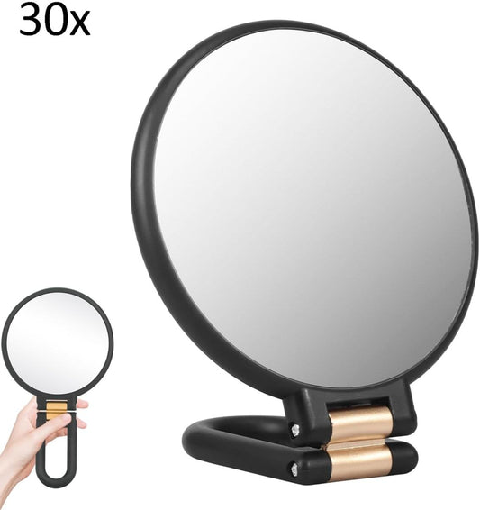 Black folding hand magnifying mirror with round dual mirror faces and gold-toned hinge