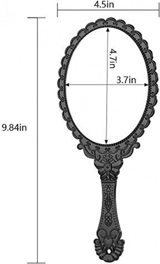Black oval hand mirror with ornate scalloped frame and decorative handle