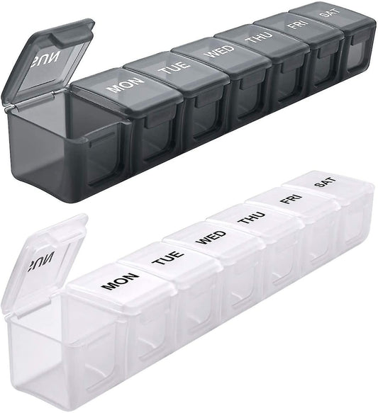 Dark weekly pill organizer box with hinged lids labeled Mon–Sun, set of 2