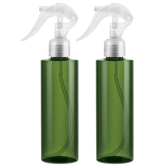 Pair of green travel spray bottles with white trigger sprayers
