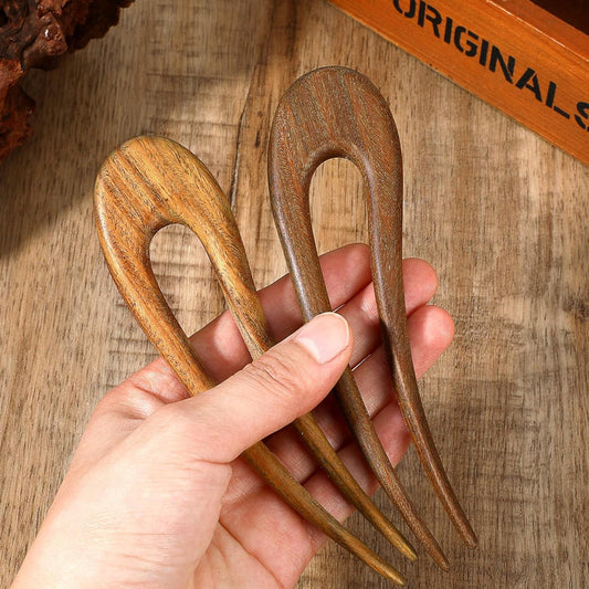 Wooden U-shaped hair fork pins with prongs in hand, dark and light brown