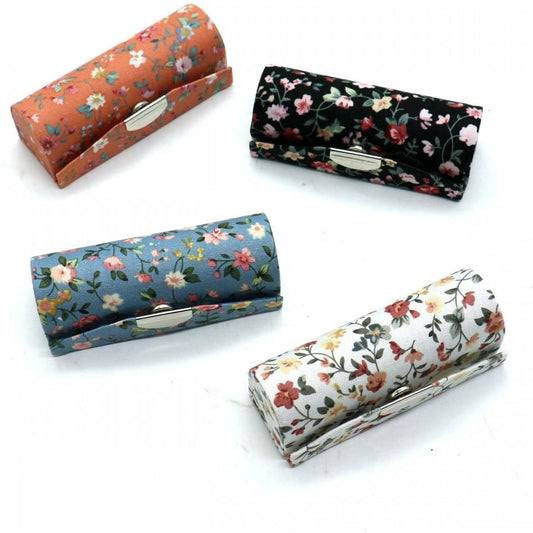 Set of four floral lipstick storage cases with hinged lids and mirror pockets