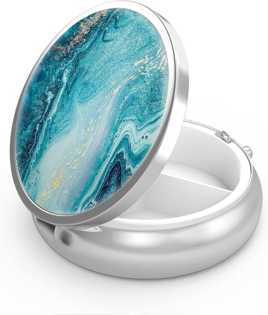 Three-compartment metal pill box, blue marbled lid, hinged open